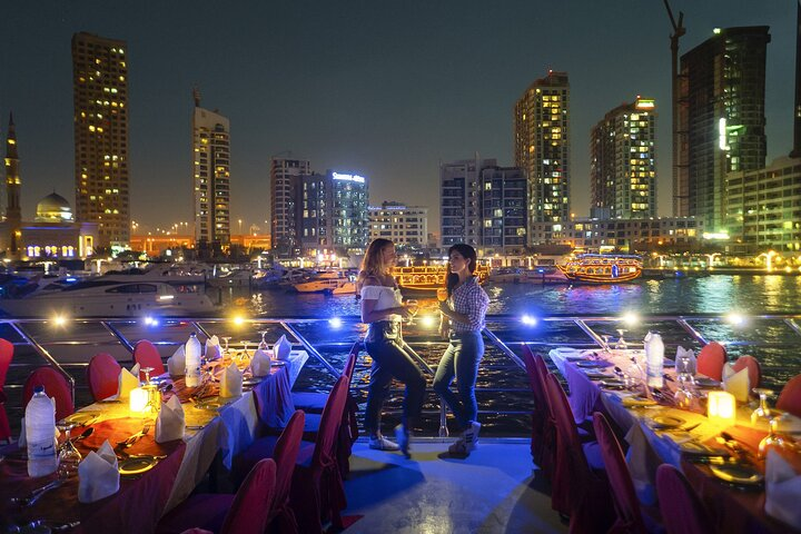 Experience the charm of dining on a traditional dhow while sailing through Dubai Marina surrounded by stunning city lights and the serene waters creating unforgettable memories.